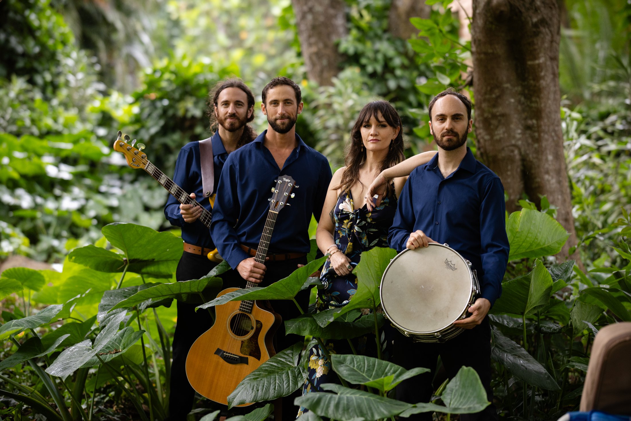 The Golden Hour Collective band portrait among tropical foliage